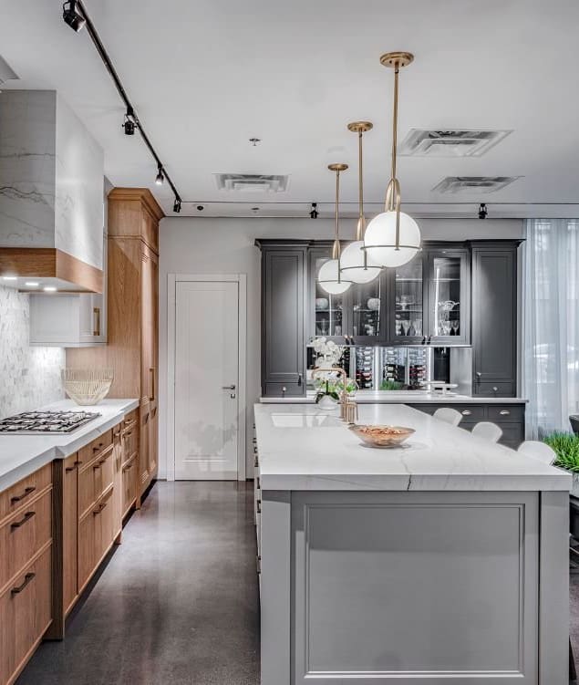 A kitchen with white counters and wooden cabinets.