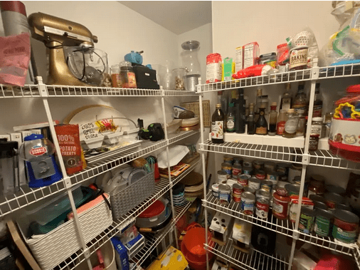 A pantry with many shelves of food and appliances.