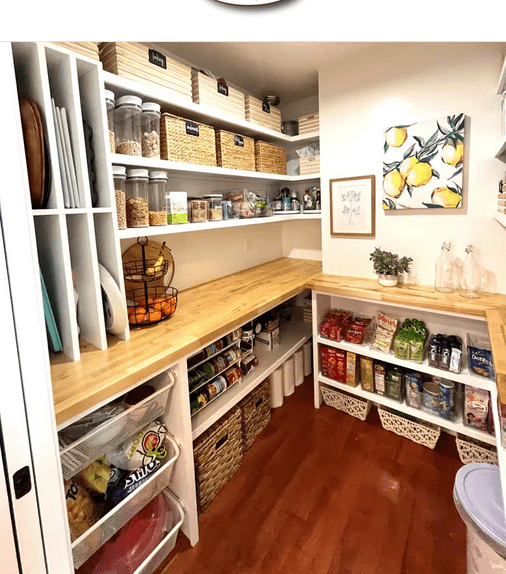 A pantry with lots of shelves and baskets.