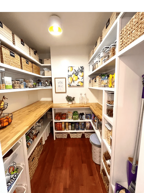 A pantry with lots of shelves and baskets.