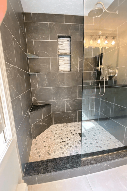 A bathroom with a shower and tiled floor