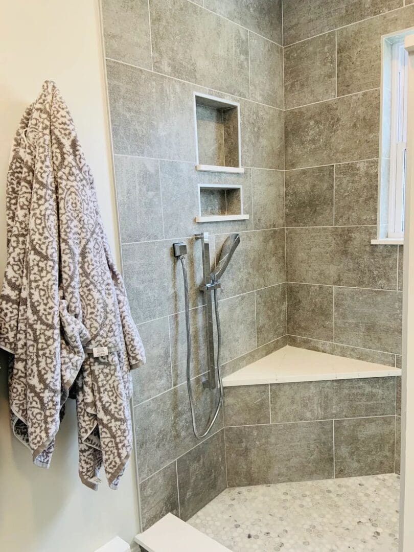 A bathroom with a shower and tiled walls.