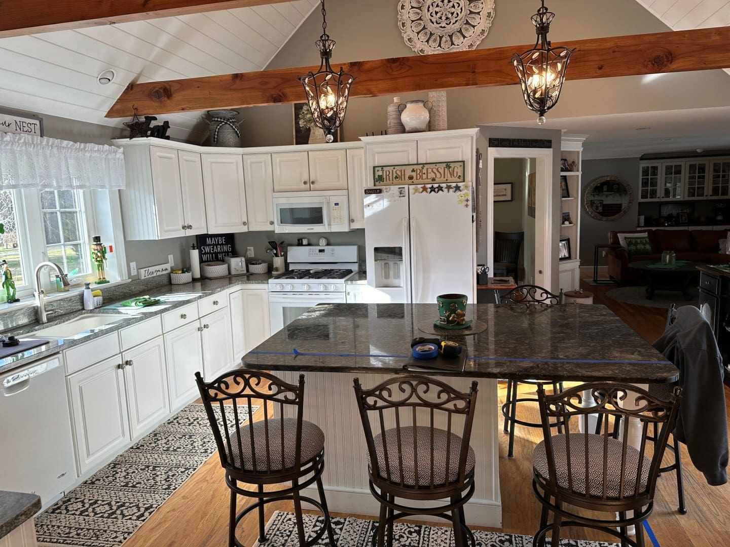 a kitchen with a dining table and three chairs